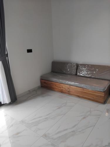 a couch sitting in the corner of a room at Sujiwa Ubud Hotel & Villa in Ubud