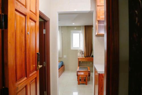 a room with a hallway with a kitchen and a door at Dragon Hotel & Apartments Đà Nẵng in Da Nang