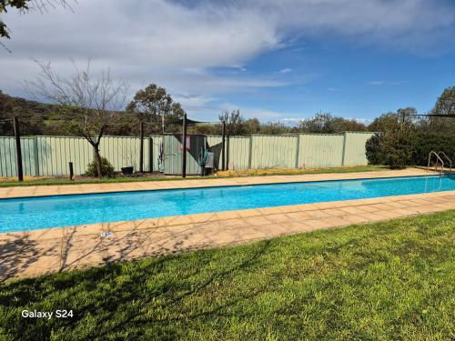 a swimming pool in a yard with a fence at Lavendale Country Retreat in York
