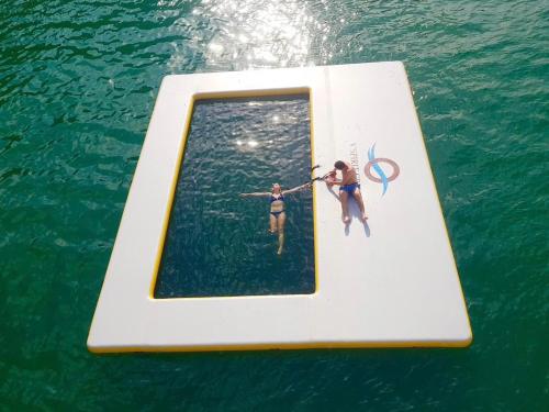 two people are on a raft in the water at V'Spirit Cruise in Ha Long