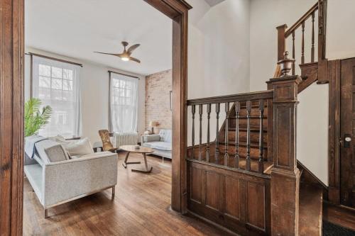 a living room with a staircase and a chair and a couch at 3-BR Historic Home Nestled Btw Petworth & CoHi in Washington, D.C.