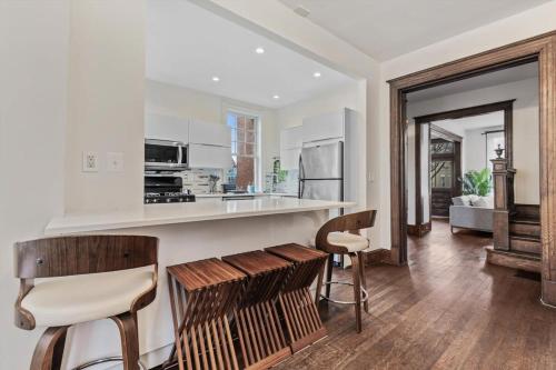 a kitchen with a counter and two stools at 3-BR Historic Home Nestled Btw Petworth & CoHi in Washington, D.C.