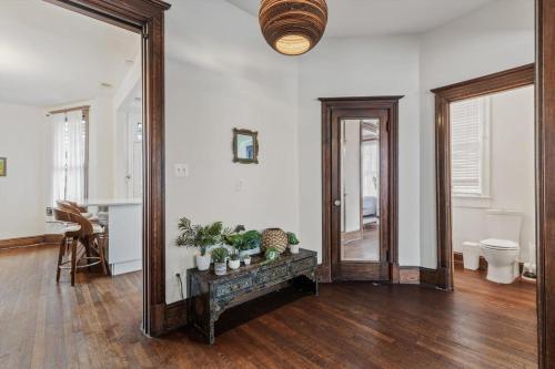 a large mirror in a living room with wooden floors at 3-BR Historic Home Nestled Btw Petworth & CoHi in Washington, D.C.