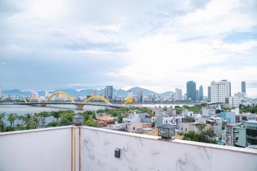 a view of a city with a bridge and buildings at Dragon Hotel & Apartments Đà Nẵng in Da Nang