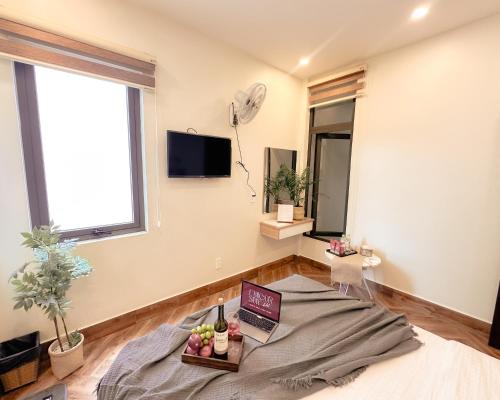 a living room with a bed and a window at L'amour Stay Dalat in Xuan An
