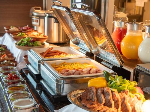 a buffet line with many different types of food at remm plus Kobe Sannomiya in Kobe