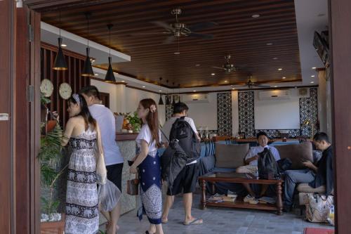 a group of people standing in a living room at Jasmine Luangprabang Hotel in Luang Prabang