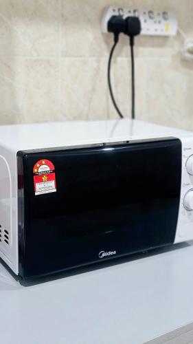 a toaster sitting on top of a white counter at HeySnowy 8-15pax #FreeNetflix #Gated &Guarded #Water Dispenser #Mahjong in Kluang