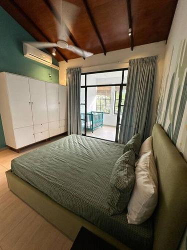 a bedroom with a bed and a large window at Spacious 3-Bedroom House in Colombo in Bokundara