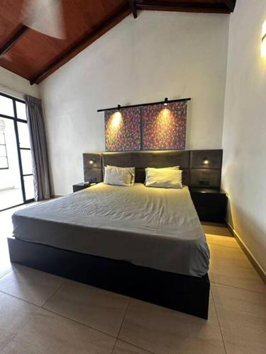 a bedroom with a large bed in a room at Spacious 3-Bedroom House in Colombo in Bokundara
