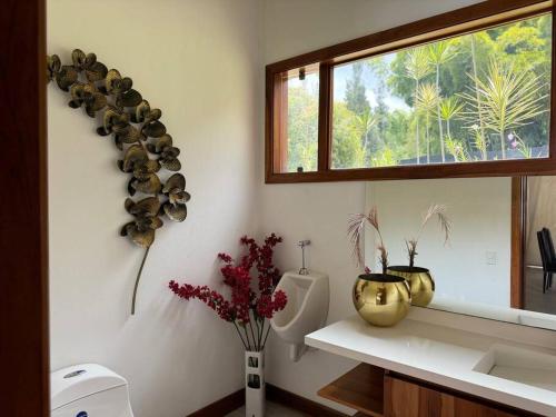 a bathroom with a sink and a window at Bali Villa lujo en el oriente in Rionegro
