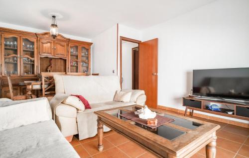 a living room with a couch and a table at Pet Friendly Apartment in El Puerto de Santa María