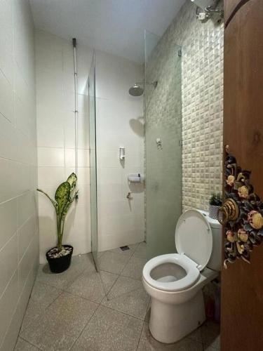 a bathroom with a toilet and a glass shower at Permata Tojan Blok A3 in Ubud