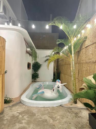 an elephant in a bath tub with a palm tree at Gờ Home Phan Thiết in Ấp Sung Xuân