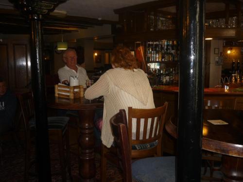 
a man sitting at a table in a restaurant at The Darnley Arms in Gravesend
