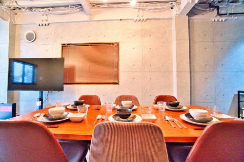 a dining room table with chairs and a wooden tableablish at Tokyo Oasis Heiwajima in Tokyo