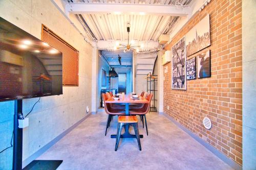 a dining room with a table and chairs and a tv at Tokyo Oasis Heiwajima in Tokyo