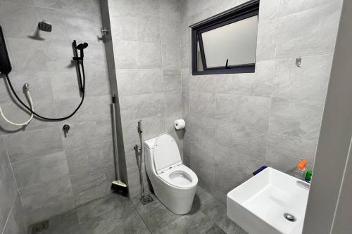 a bathroom with a toilet and a sink at Sunsuria Forum - Azumi Homes in Setia Alam