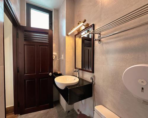 a bathroom with a sink and a mirror at L'amour Stay Dalat in Xuan An