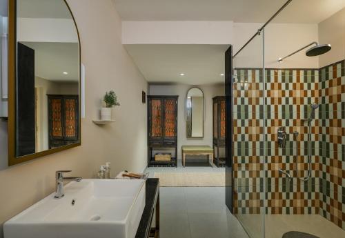 a bathroom with a sink and a shower at Kshemavana The Wellness Retreat in Bengaluru