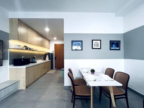 a dining room and kitchen with a table and chairs at Sunsuria Forum - Emi Homes in Setia Alam