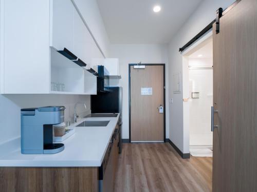 a kitchen with a sink and a counter top at Cambria Hotel El Centro - Imperial in El Centro