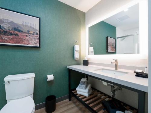 a bathroom with a white toilet and a sink at Cambria Hotel El Centro - Imperial in El Centro