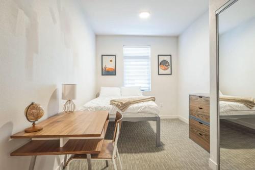a bedroom with a bed and a desk and a table at Chic and Modern Getaway with Gym 5 Min to Downtown in Boise