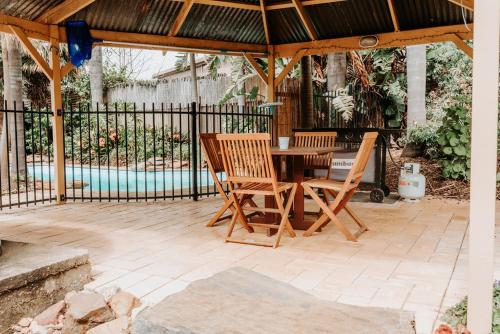 a patio with a table and chairs under a gazebo at Cole-Brook Cottage Historic House in McLaren Vale