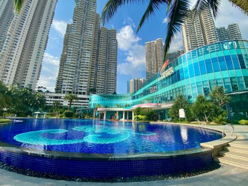 a large pool in a city with tall buildings at Country Garden Danga Bay,Full Seaview, 6-8pax, Netflix in Johor Bahru