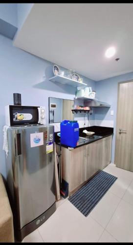 a kitchen with a refrigerator and a counter top at FourSphere staycation in Manila
