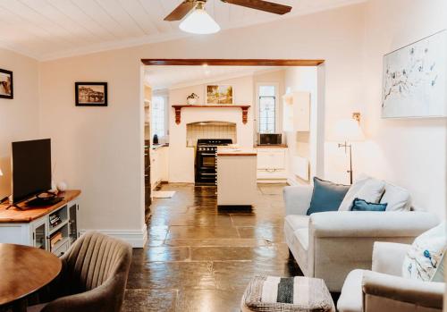 a living room with a couch and a table at Cole-Brook Cottage Historic House in McLaren Vale