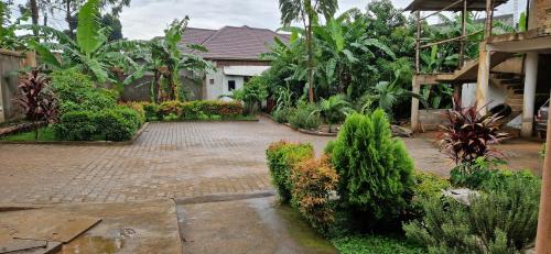 a courtyard of a house with trees and plants at Biocity Home Kampala in Kampala