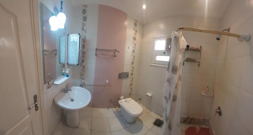 a bathroom with a toilet and a sink at 2 Bedroom apartment on luxury delta Sharm resort in Sharm El Sheikh