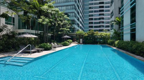 a swimming pool in the middle of a building at Aruga Apartments by Rockwell Makati in Manila
