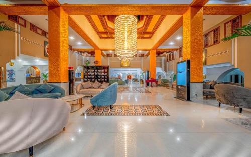 a lobby with couches and chairs and a chandelier at Domina Coral Bay Resort, Diving , Spa & Casino in Sharm El Sheikh