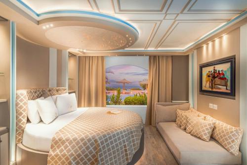 a bedroom with a bed and a couch at Domina Coral Bay Resort, Diving , Spa & Casino in Sharm El Sheikh