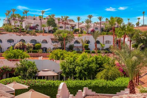 a view of a resort with palm trees and buildings at Domina Coral Bay Resort, Diving , Spa & Casino in Sharm El Sheikh