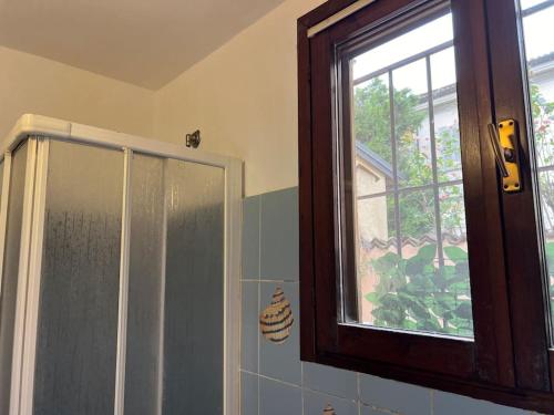 a bathroom with a shower and a window in it at La tana moderna in Piacenza
