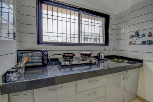 a kitchen with a counter top and a microwave at IT'S HOME in Aurangabad