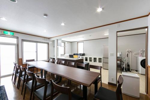 a dining room with a long table and chairs at The North Peak Nakafurano in Nakafurano