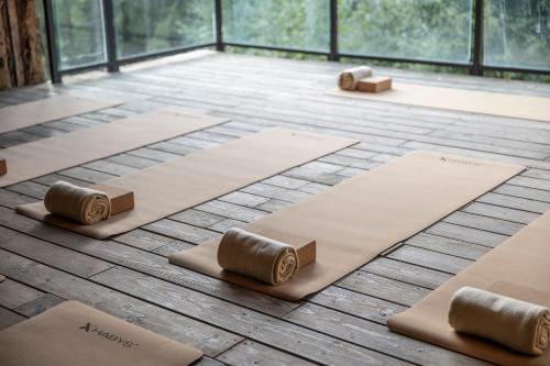 a room with four yoga mats on the floor at Pytloun Wellness Hotel Harrachov in Harrachov