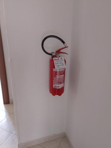 a fire extinguisher hanging on a wall at Casa Stella in Savona