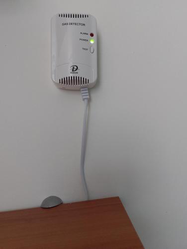 a speaker hanging on a wall next to a table at Casa Stella in Savona
