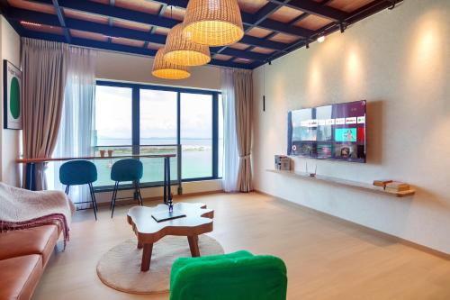 a living room with a couch and a table at Sunrise Gurney in George Town