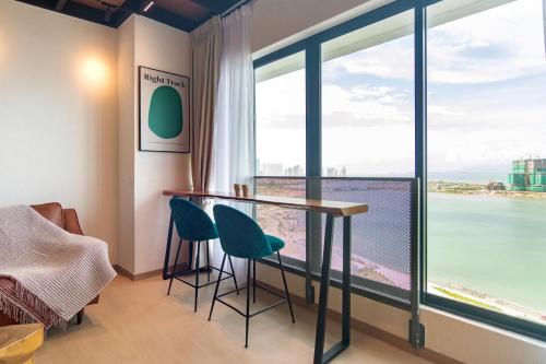 a room with a table and chairs and a large window at Sunrise Gurney in George Town