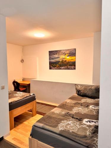 a room with two beds and a painting on the wall at Donea Home Service in Schönebeck