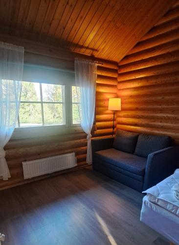a living room with a couch and a window at Rustholli City Cottage Tampere in Tampere