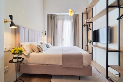 a hotel room with a bed and a television at iloftmalaga Comedias in Málaga