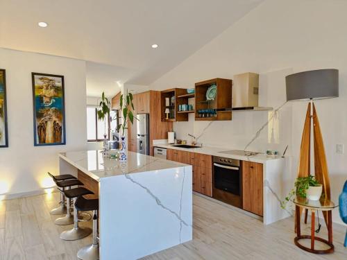a kitchen with a white island in a room at Unit 216-Casa Ricardo-Ocean View RENOVATED in Cabo San Lucas
